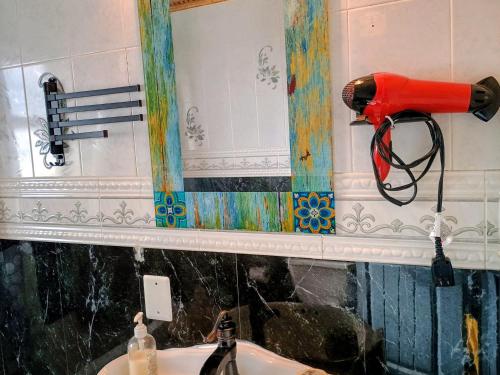 a blow dryer on a wall next to a sink at Explore New York from Queens in Queens
