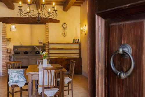 a kitchen and dining room with a table and chairs at Scappo in Umbria, casale della quiete in Montecchio