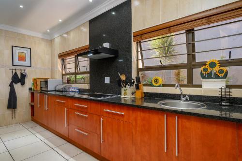a large kitchen with a sink and a window at Seagull Villa in Margate