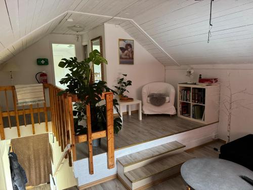 a room with stairs and a table and a chair at Lägenhet i Kosta in Kosta