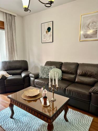 a living room with a leather couch and a coffee table at Nemesis in Podgorica