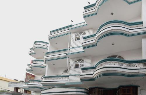 a building with balconies on the side of it at Super Hotel O Maa Residency in Jammu
