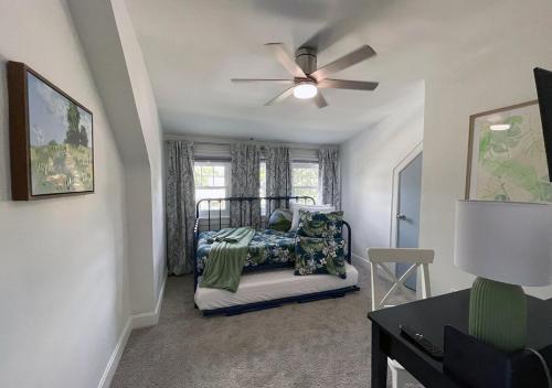 a bedroom with a bed and a ceiling fan at Cozy Campbell Bungalow in Columbus