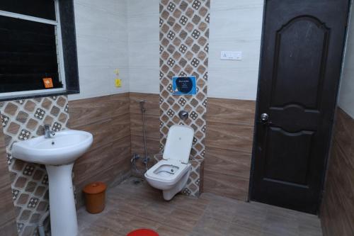 a bathroom with a toilet and a sink at Hide away stay in Pune