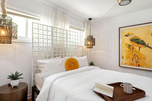 a white bedroom with a large bed with a wooden table at Joshua Tree in Atlanta