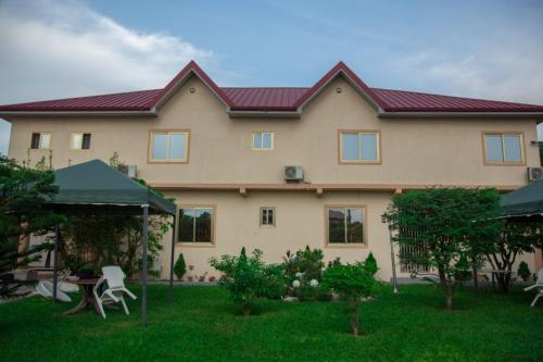 a large house with a red roof at Magnolia lodge in Accra