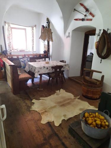 a living room with a table and a bowl of fruit on the floor at Gorshof in Spital am Pyhrn