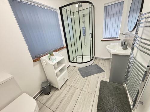 a bathroom with a shower and a sink at Gatwick Studio in Horley