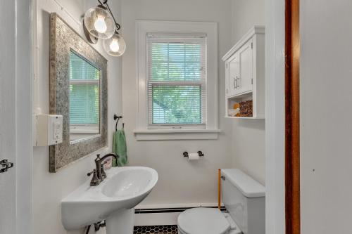 a white bathroom with a sink and a toilet at The Exquisite Villa by Granger Gardens in Ann Arbor