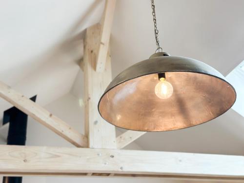 a metal light hanging from a ceiling at Gite d'exception au Château in Le Fief-Sauvin