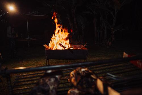 a fire pit with a bunch of fire in it at Spice Nest Resort in Kangaru
