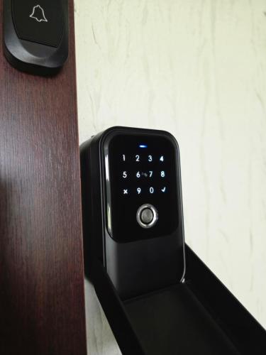 a black remote control sitting on top of a table at DOMINO apartamentai, SELF CHECK-IN in Panevėžys