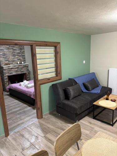 a living room with a couch and a bed at Central House in kastraki in Mesochórion