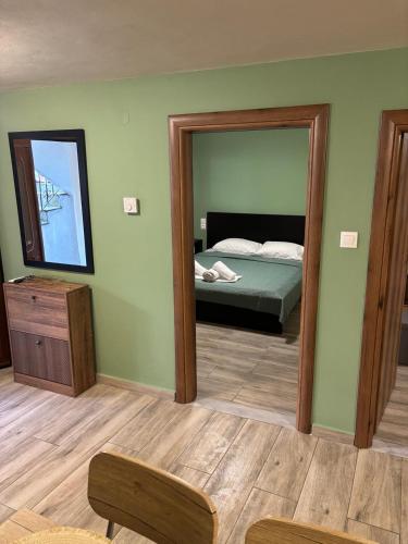 a bedroom with a mirror and a bed in it at Central House in kastraki in Mesochórion