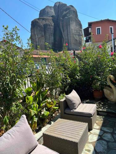 a patio with two chairs and a statue of a rock at Central House in kastraki in Mesochórion