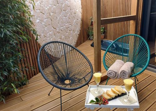 a table with two chairs and a plate of food at Dream cube & Spa in Coutevroult