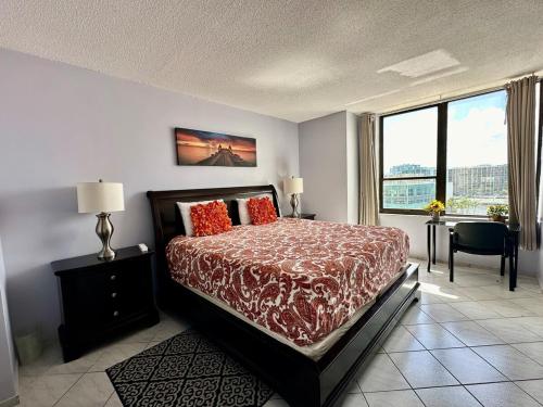 a bedroom with a bed and a large window at Beach condo with great views for your worry free vacation in Hollywood FL in Hollywood