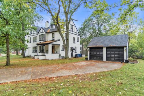 a large white house with a large garage at The Chateau de James by Granger Gardens in Ann Arbor