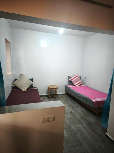 a room with two beds in a room at Dar ifoulki in Wassane