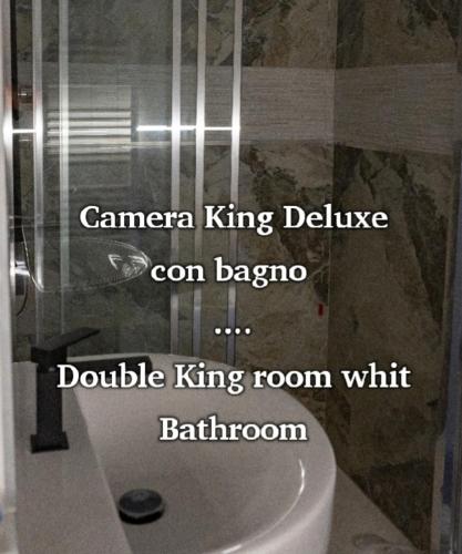 a bathroom with the words camera king bathroom con baez double king room with at PALAZZO NOVECENTO Centro Storico in Lecco