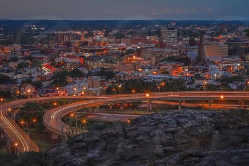 a city at night with a highway and street lights at Bright, Stylish and Comfy Luxury Room With Workspace! in Haledon
