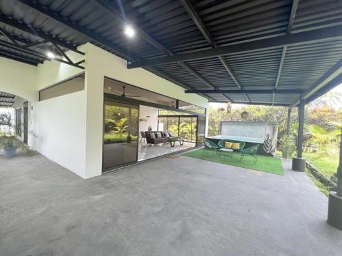 an open patio with a couch and a table at Fruit Villa Uvita in Uvita