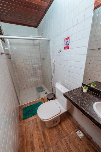 a bathroom with a shower and a toilet and a sink at Casa c 4 suites, Piscina, Churrasqueira e Garagem in Cabedelo