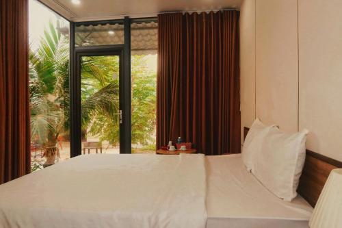 Ένα ή περισσότερα κρεβάτια σε δωμάτιο στο Serene Homestay