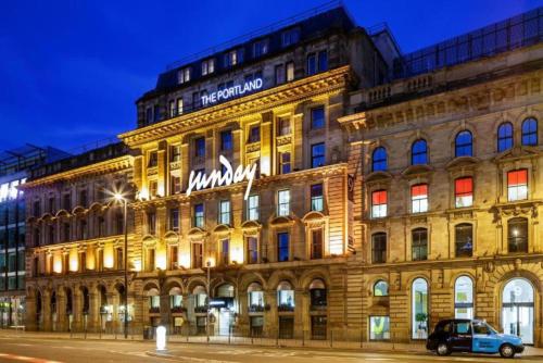 a building with a sign on the front of it at Manchester Portland By Sunday in Manchester