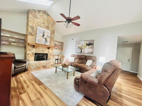 a living room with a couch and a fireplace at Modern Charm in Knoxville