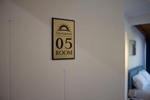 a sign on a wall that reads the tenthos room at The Horizon in Berat