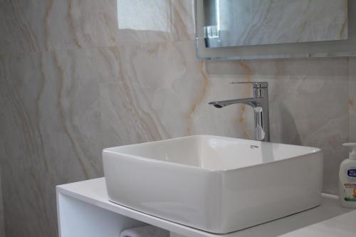 a bathroom with a white sink and a mirror at The Horizon in Berat