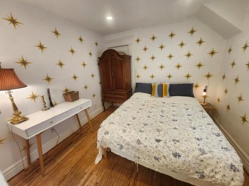 a bedroom with a bed with stars on the wall at Garden View double room suite at Trout Lake in Vancouver