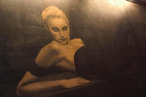 a painting of a woman in a black dress at Hotel La Perla Del Golfo in Procchio