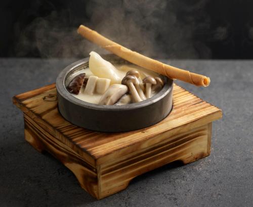 a bowl of food on top of a wooden box at Crowne Plaza Changi Airport by IHG in Singapore
