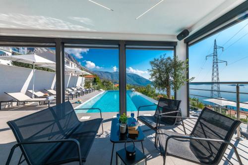 a view of the pool from the patio of a house at Apartments Villa Poco Loco in Mlini