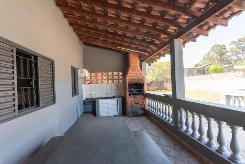 a balcony of a house with a fireplace at Chacara Silveira lazer completo a 5 min do centro in Araçoiaba da Serra