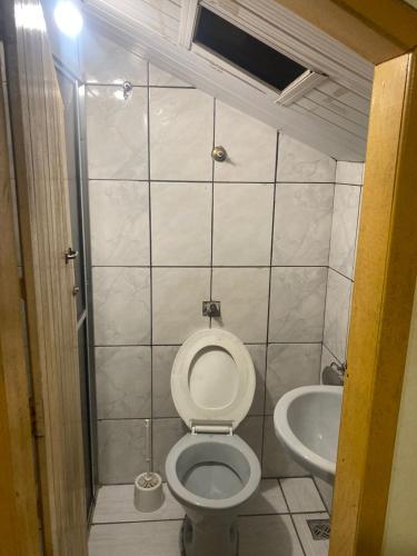 a bathroom with a toilet and a sink at República Acrópole in Ouro Preto