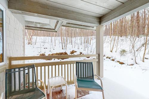 two chairs sitting on a porch in the snow at Trailside Highlands 20C in Jeffersonville