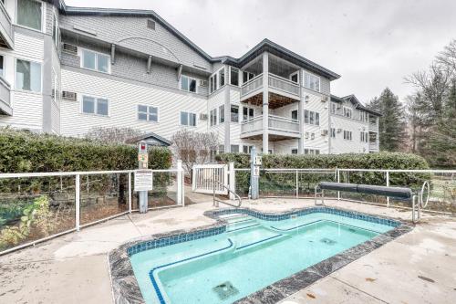 a house with a swimming pool in front of a house at Trailside Highlands 20C in Jeffersonville