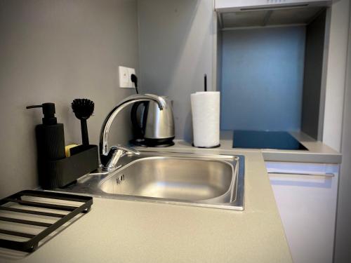 a kitchen counter with a sink in a kitchen at Nový moderný apartmán SAPEX "5" v centre mesta in Prešov