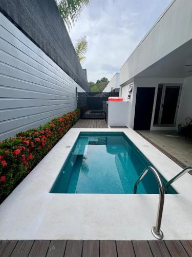 a small swimming pool next to a building at Coralita in Jacó in Jacó