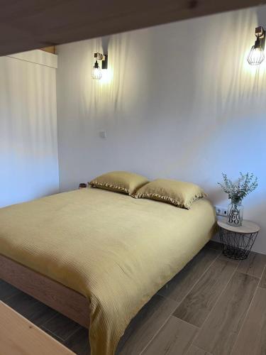 a bed in a bedroom with two lights on the wall at REFUGIO by Stay in Alentejo in São Luis