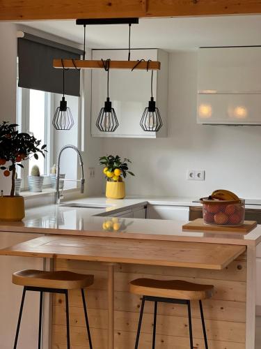 a kitchen with a wooden counter with three lights at REFUGIO by Stay in Alentejo in São Luis