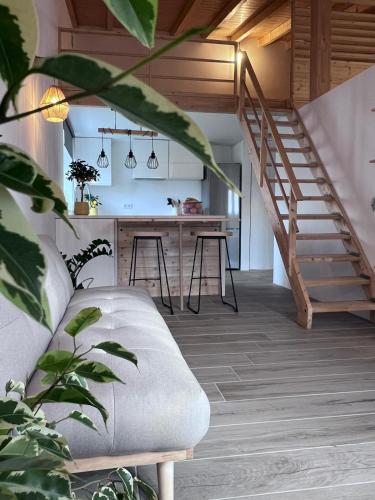 a living room with a staircase and a couch at REFUGIO by Stay in Alentejo in São Luis
