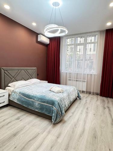 a bedroom with a bed and a large window at 2 room in the very center of the city near the mega park and walking distance to the Arbat in Almaty