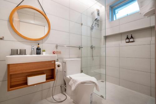 a bathroom with a toilet and a sink and a mirror at At Bangla Patong Pool Moon villa in Patong Beach