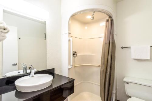 a bathroom with a sink and a shower at Motel 6-Redding, CA - Central in Redding