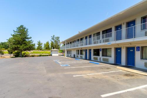 an empty parking lot in front of a hotel at Motel 6-Redding, CA - Central in Redding