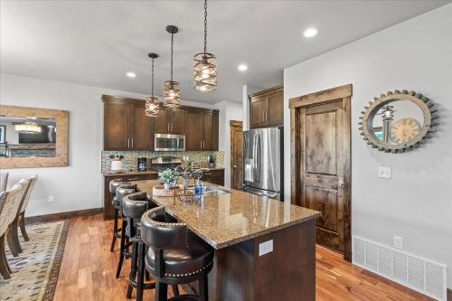 a kitchen with a large island with bar stools at Hideout Haven 4BR 10 min from Deer Valley in Keetley Junction
